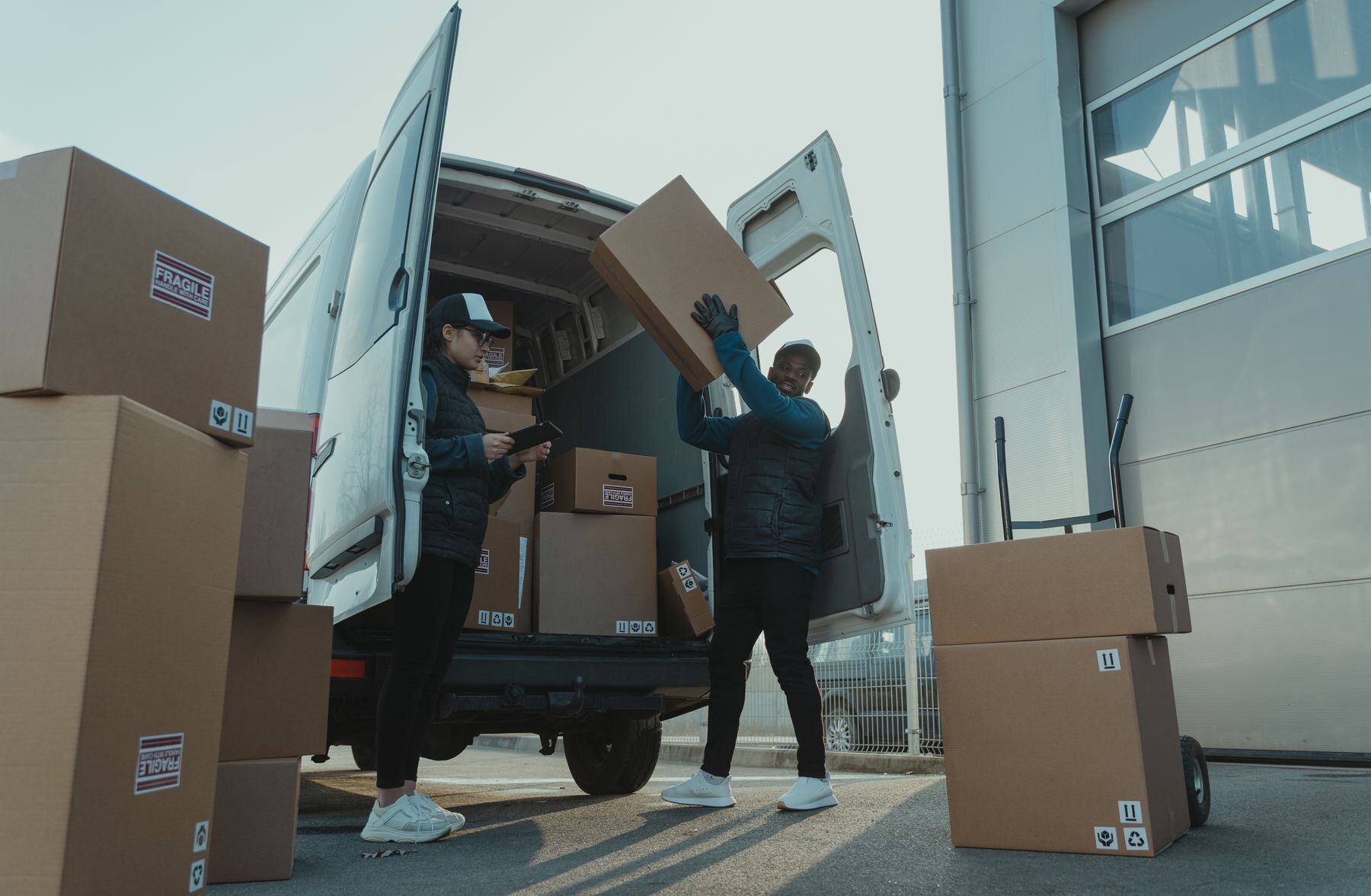A delivery crew carefully loading boxes into a van